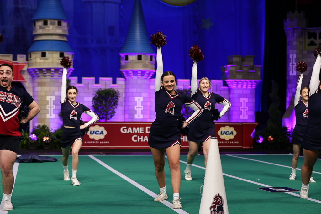 FDU Devils cheerleaders perform on the stage at Disney World. 