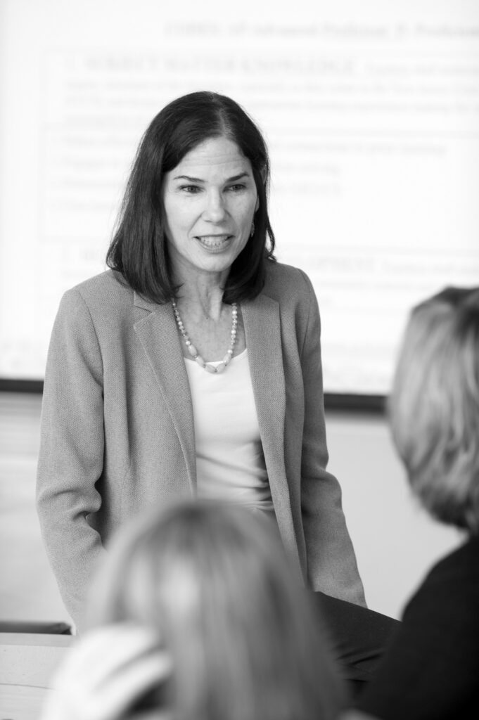 Portrait of a woman wearing a blazer. Photo is in black and white.