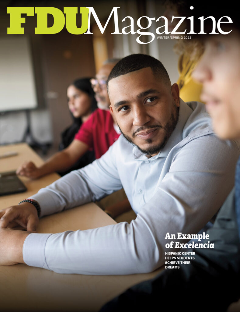 The Winter/Spring 2023 cover of FDU Magazine shows a student sitting a table.