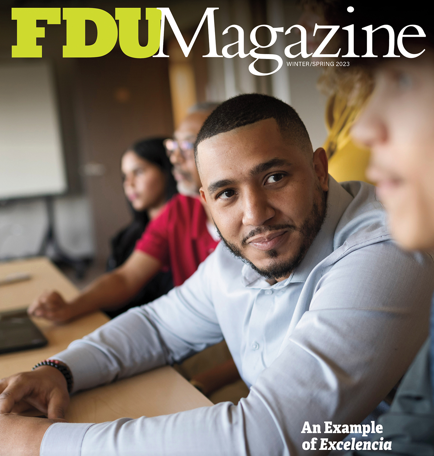 The Winter/Spring 2023 cover of FDU Magazine shows a student sitting a table.