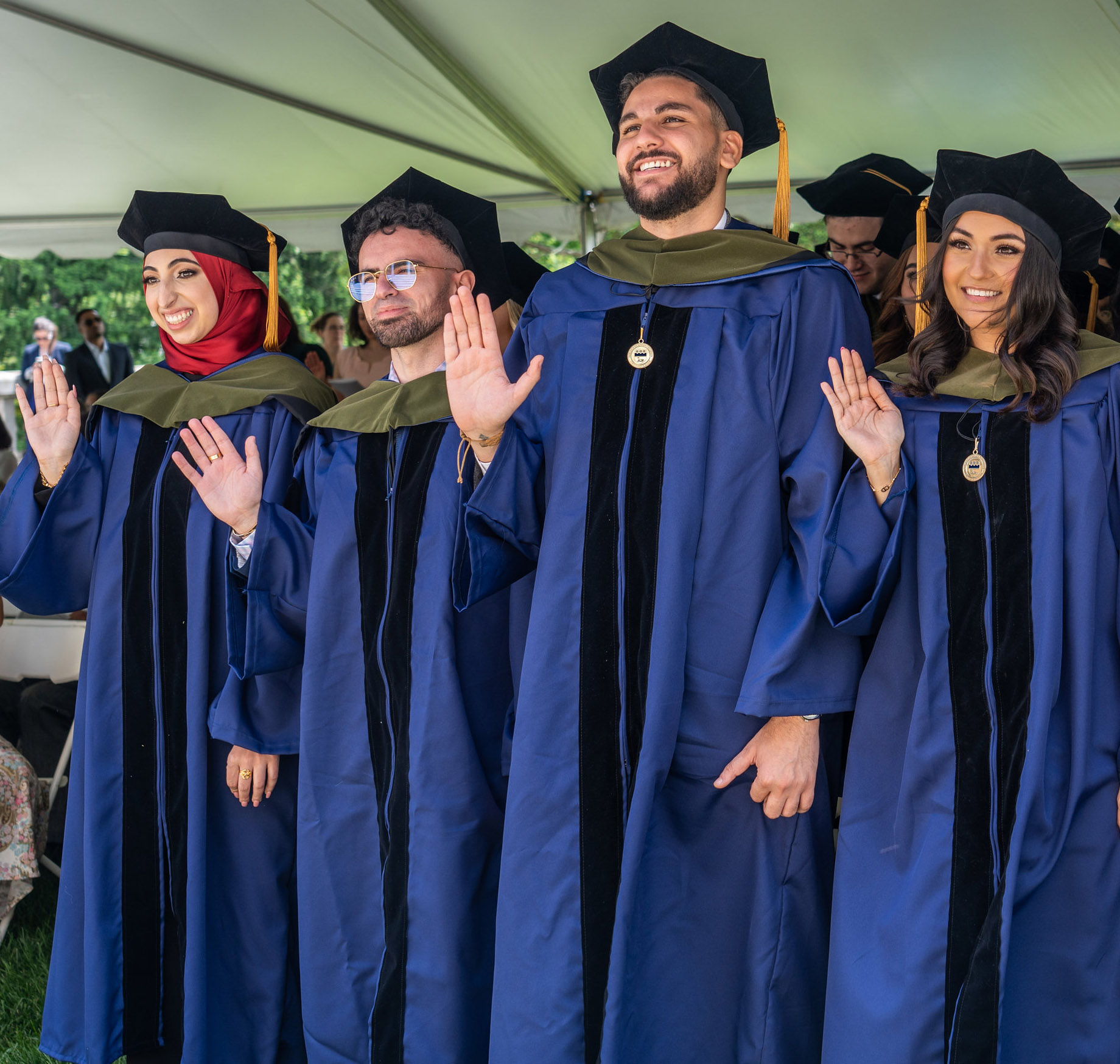 Pharmacy graduates dressed in regalia at their hooding ceremony.