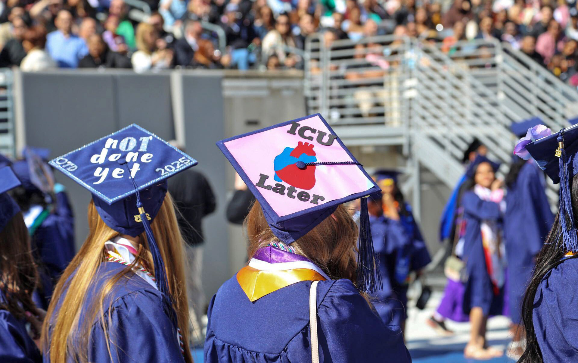 Decorated caps dot the crowd of graduates.