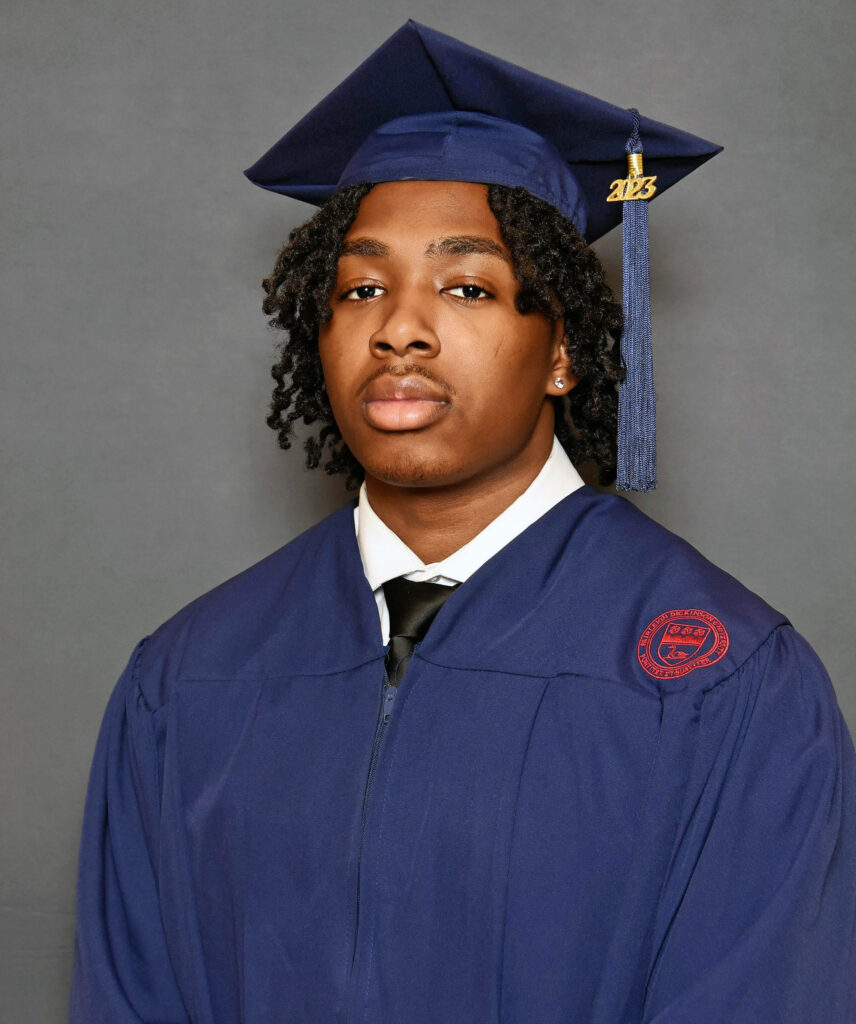 Portrait of a young man wearing a graduation cap and gown.