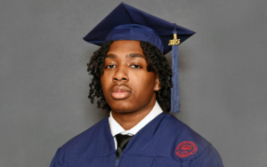 Portrait of a young man wearing a graduation cap and gown.