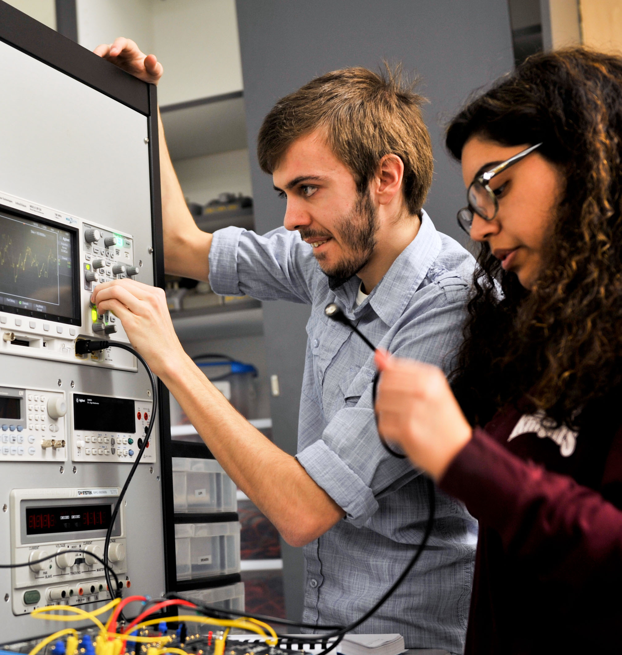 Two engineering students work in a lab.