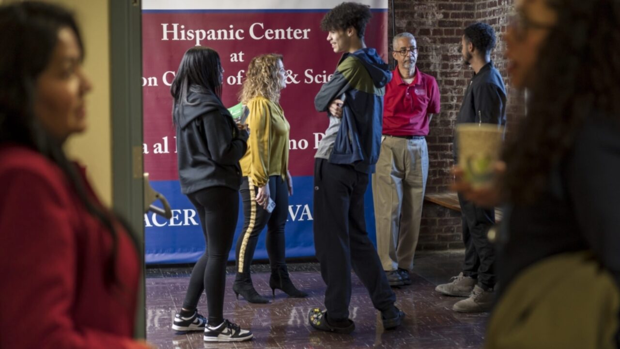 students stand and talk in hallway