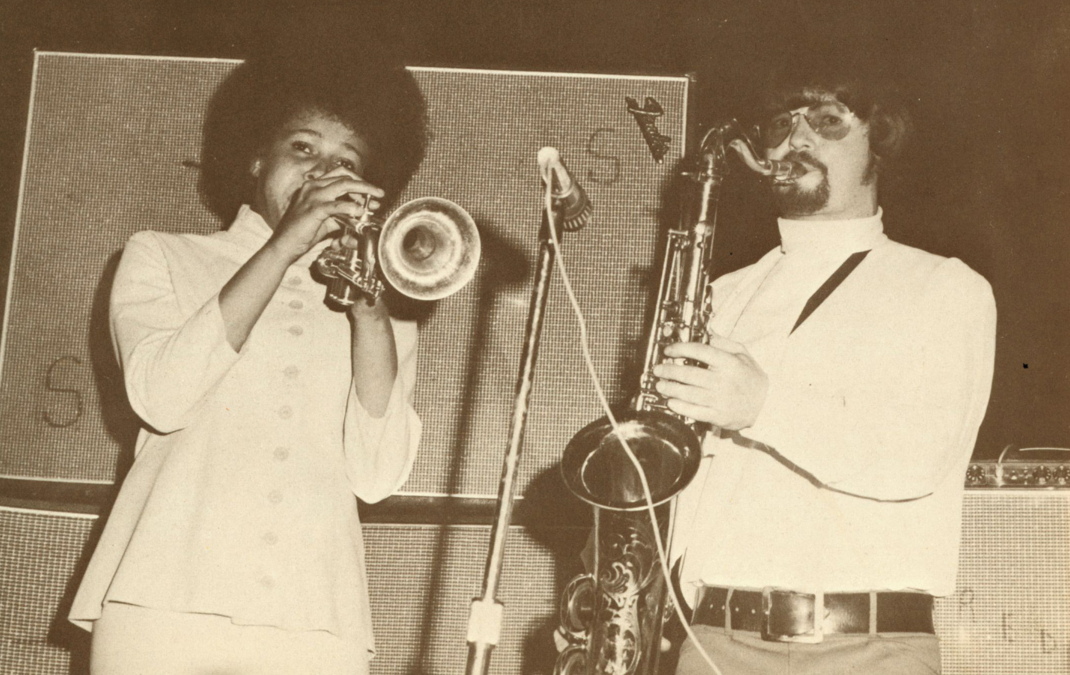 Two musicians play the trumpet and the saxophone.