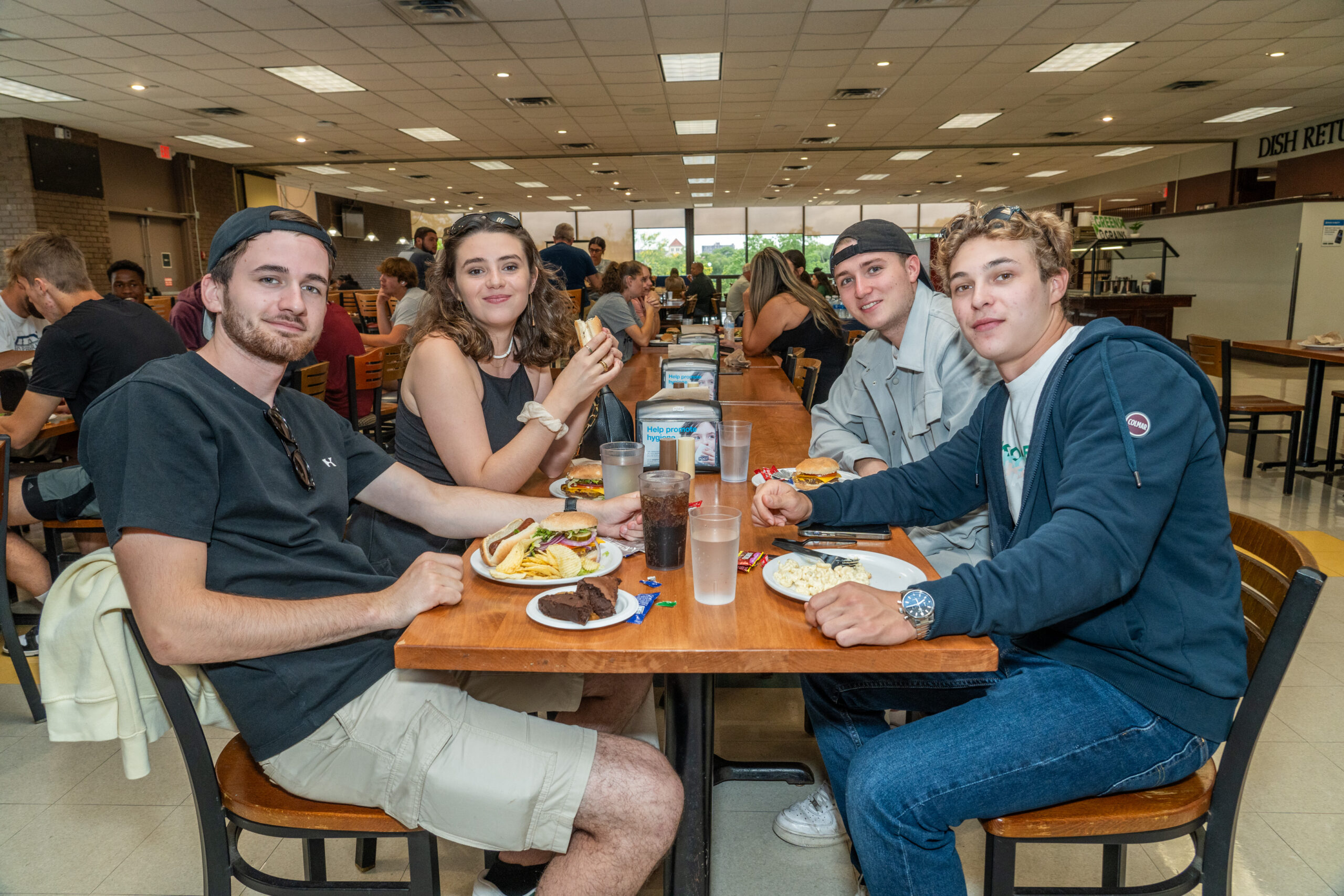 students eating at a dining hall table