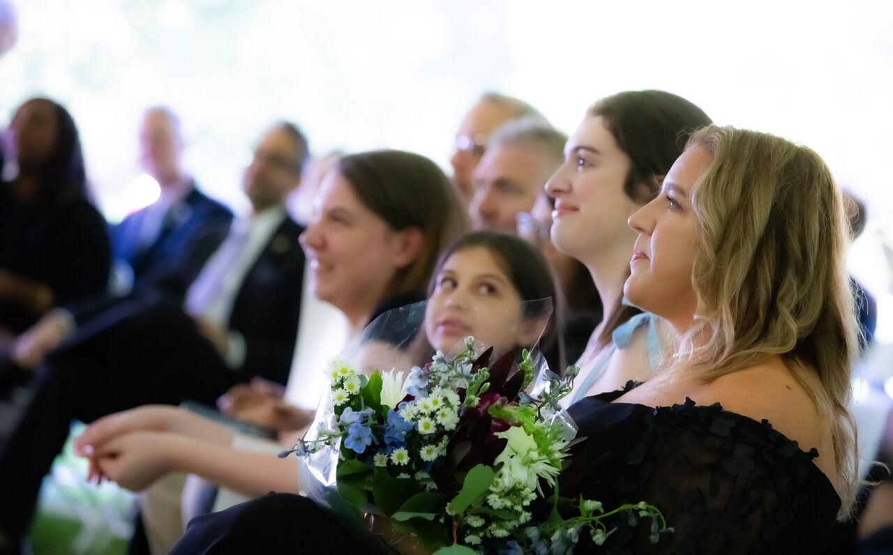 A row of female guests at the ceremony.