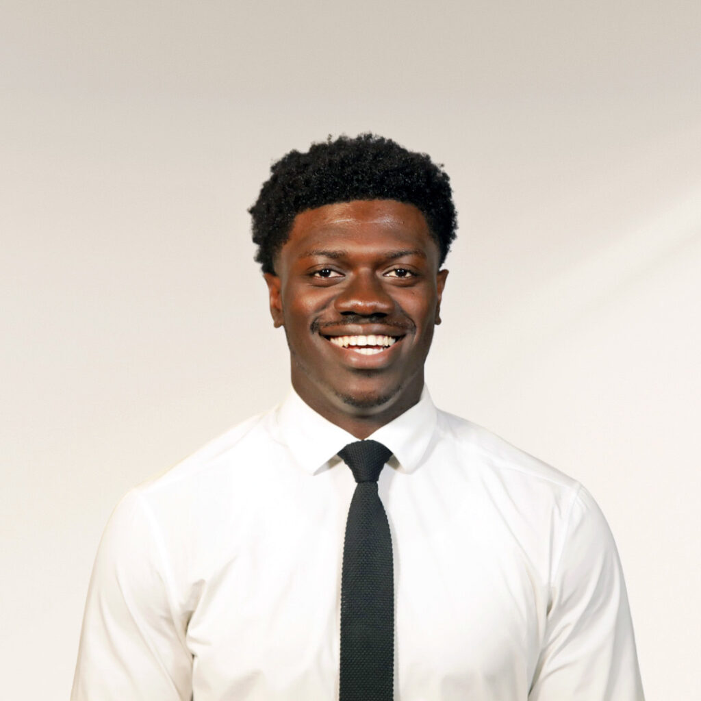 A young man wearing a tie poses for a photo.