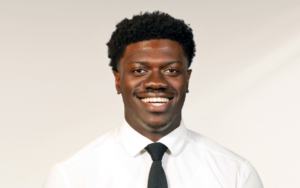 A young man wearing a tie poses for a photo.
