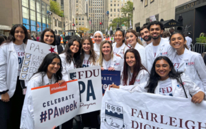 Students wearing matching T-shirts that read "FDU PA" hold signs and pose for a photo.