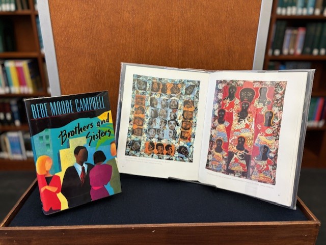 two books in a display. one book is closed and the cover reads "brothers and sisters." the other book is open to pages with artwork.