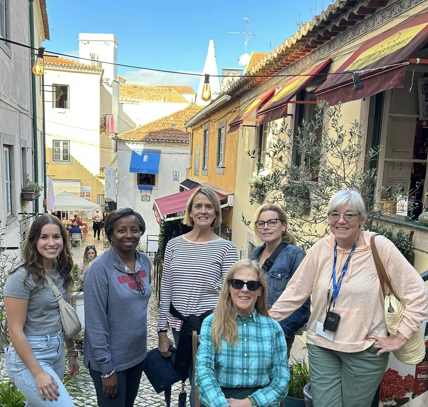 A group of women stand on the street in Portugal.