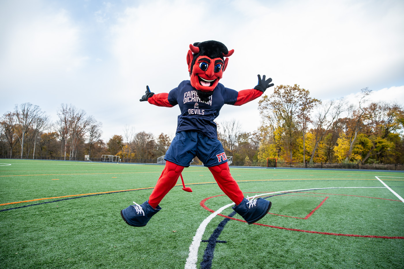 The Devil mascot leaps into the air.