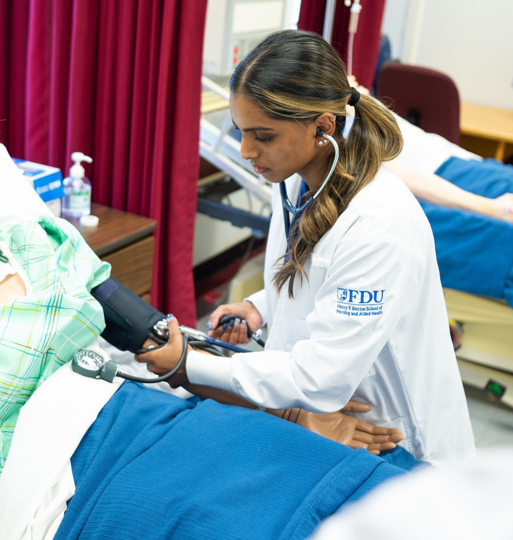 a nursing student taking blood pressure