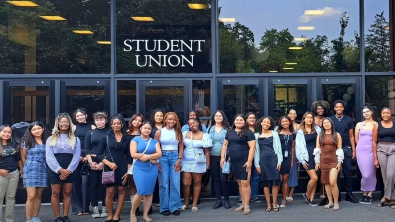 A large group of people standing in front of the Student Union door