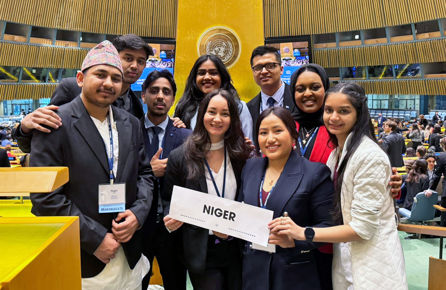 A group of students pose for a photo at the United Nations.