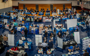 an overhead view of a career fair with various tables and students