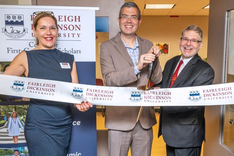 Three people cut a ribbon