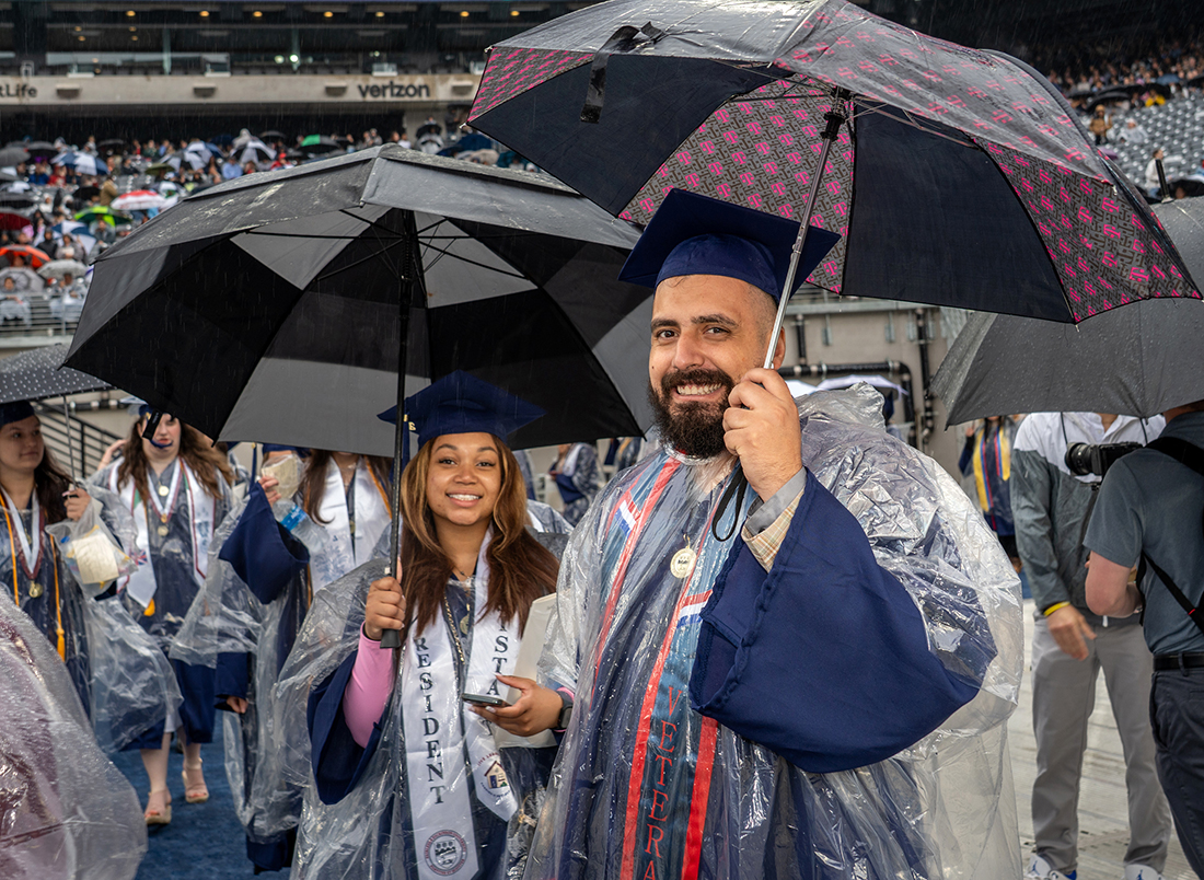 Smiling graduates in the rain.