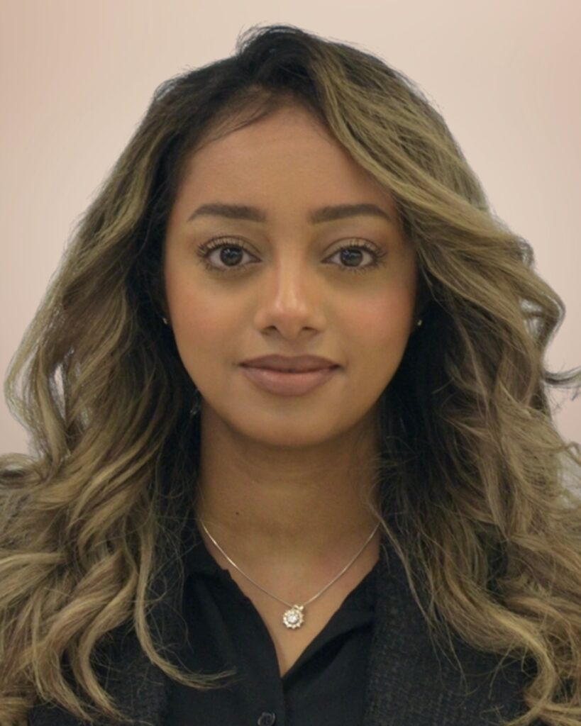 headshot of a woman. she wears a black blazer.