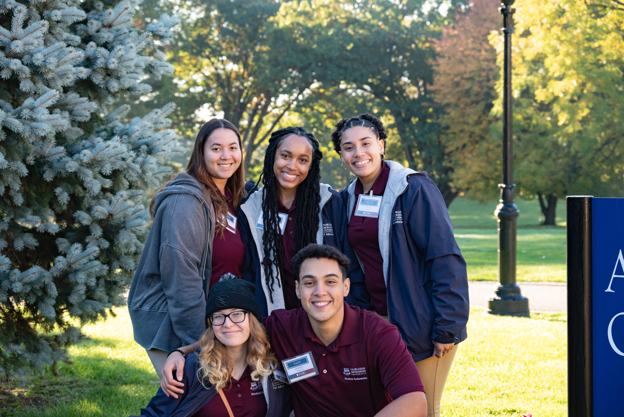 A group of five students posing for the camera.
