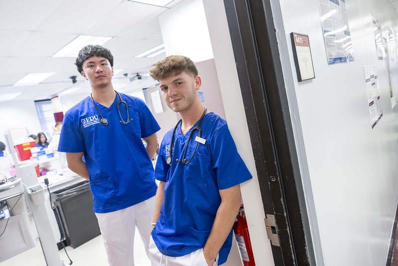 Two FDU Health students stand in the doorway to a classroom.