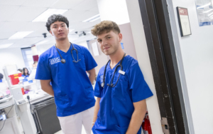 Two FDU Health students stand in the doorway to a classroom.