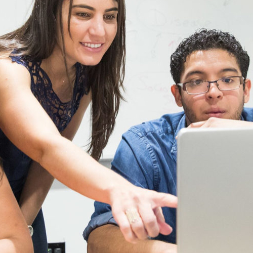 students working together behind a computer