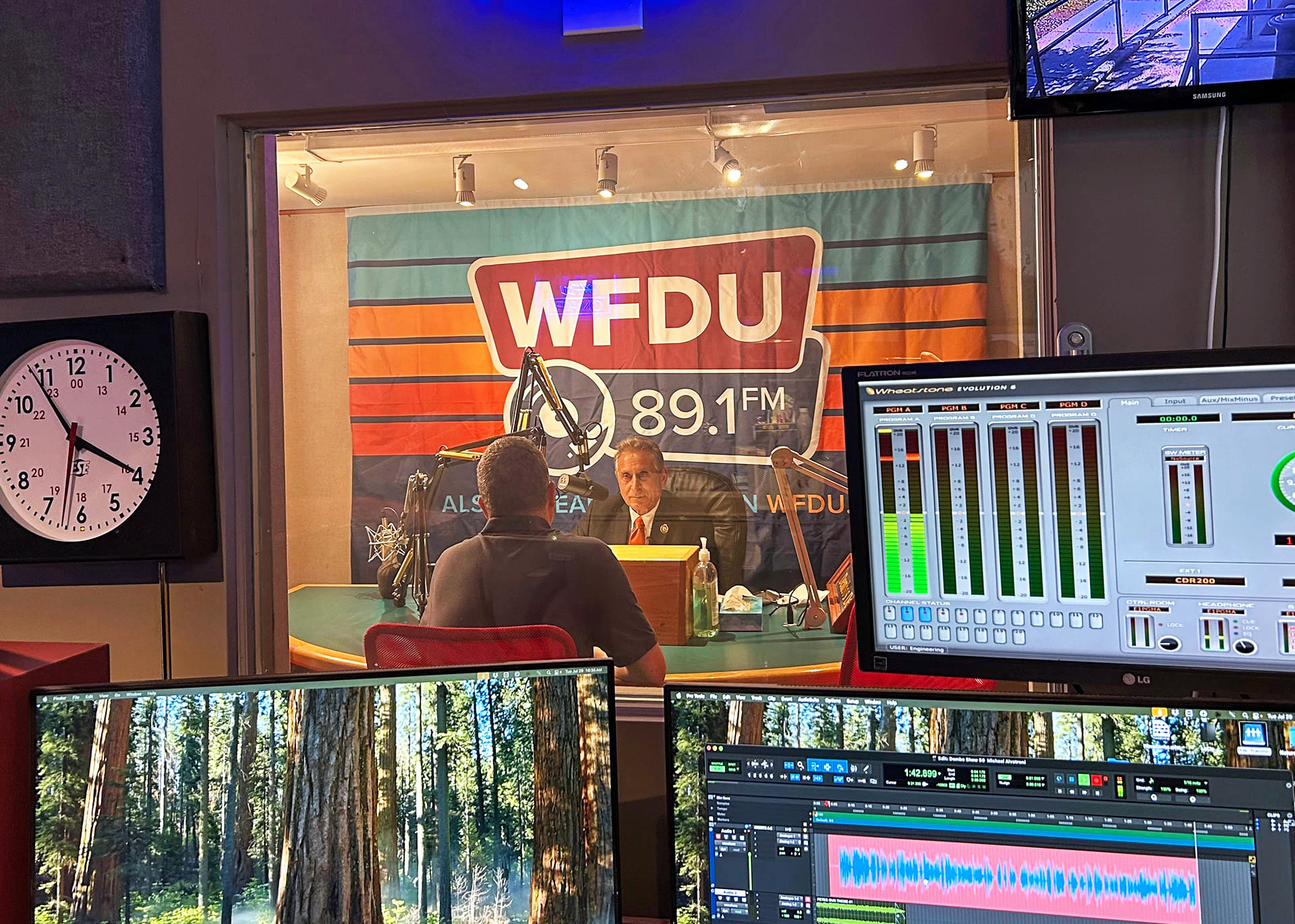 Inside a radio station as an interview airs.