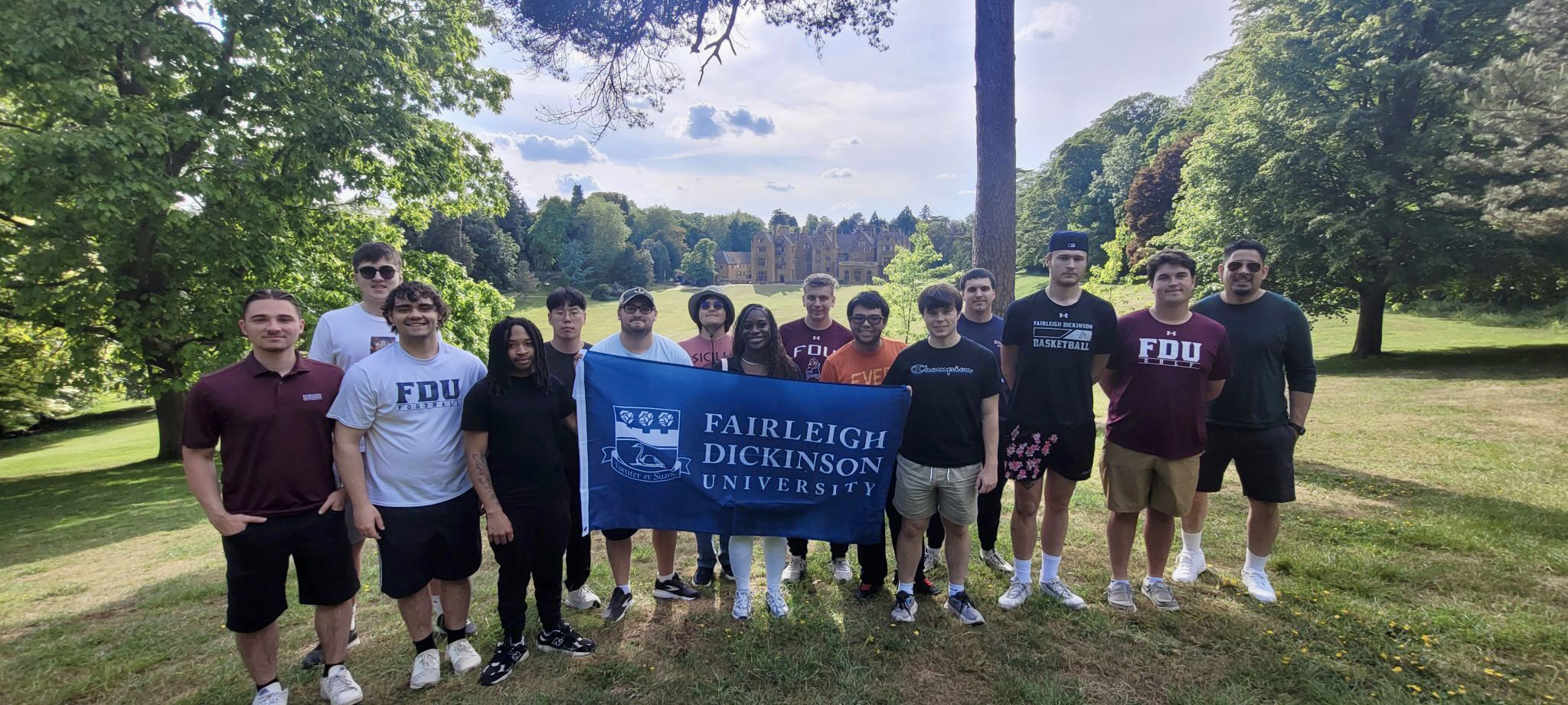 Group of students holding FDU banner in Wroxton grounds