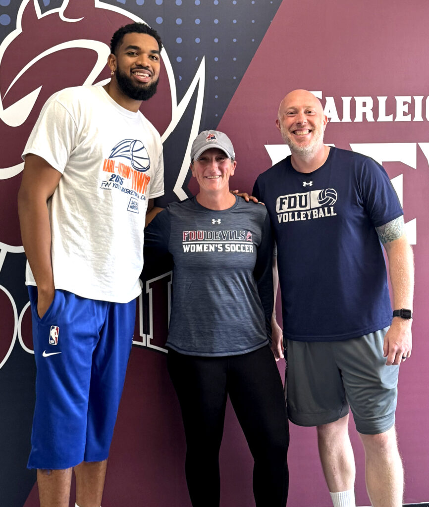 Three people in front of Devils Athletics backdrop