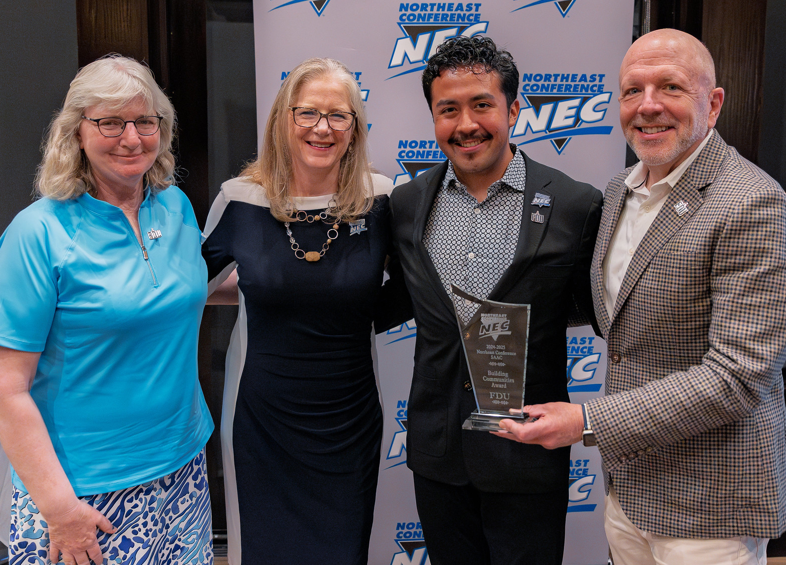 Four people at NEC Award event