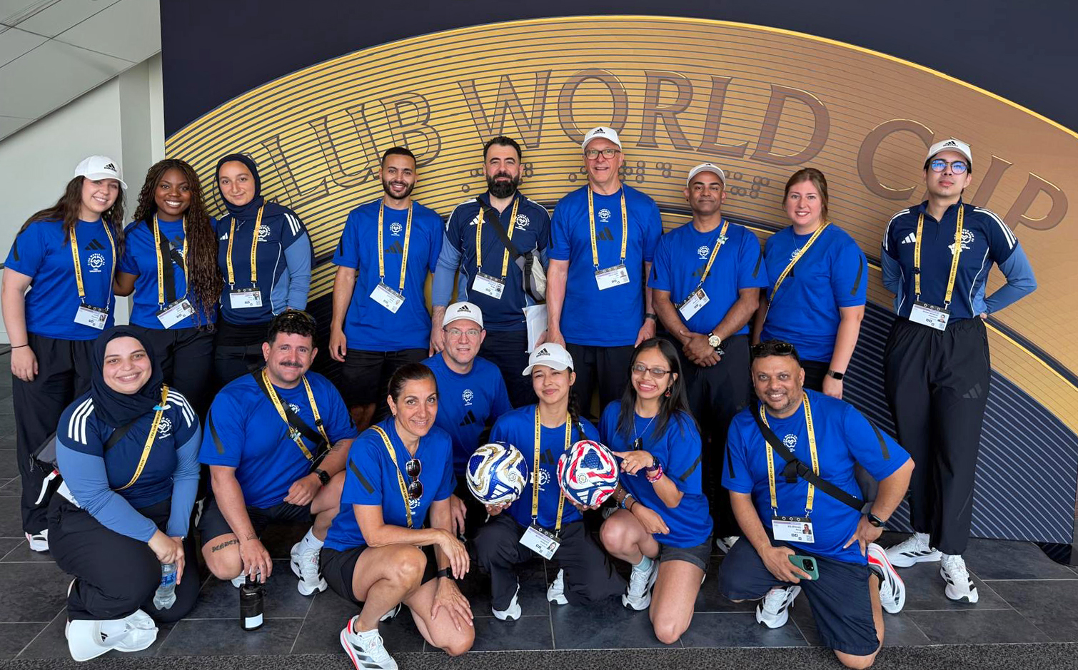 A group of FIFA volunteers pose together for a group photo.