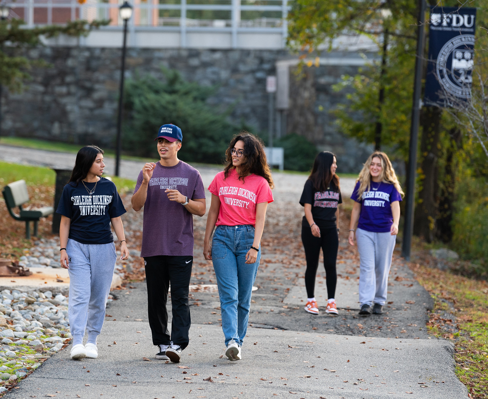A group of FDU students walk along the river at the Metro Campus.