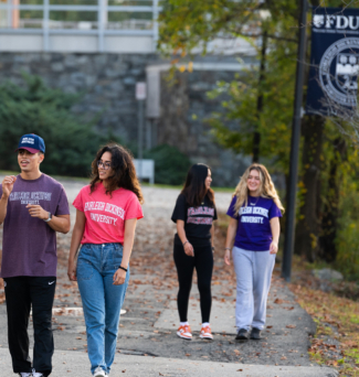 A group of FDU students walk along the river at the Metro Campus.