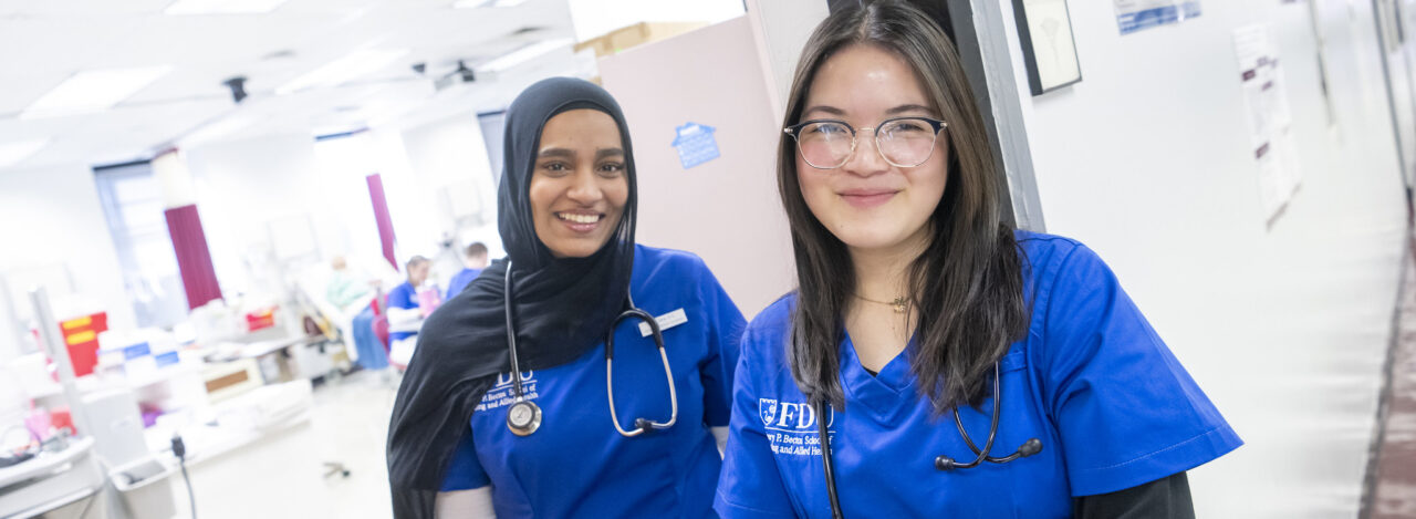 Female nursing students wear stethoscopes.