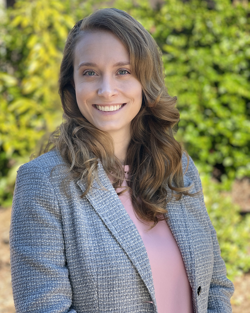 a portrait of a woman. she wears a tweed blazer.