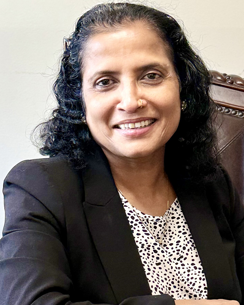 a portrait of a woman. she wears a black blazer.