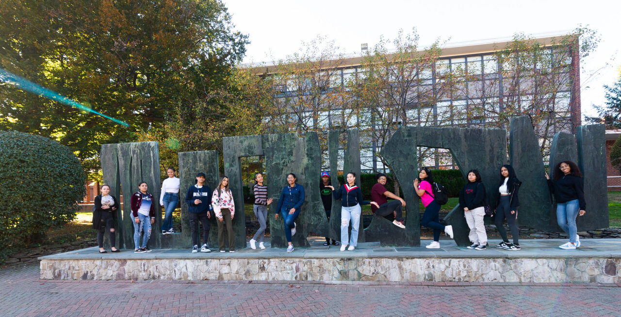 Students pose with the World Peace Screen sculpture.