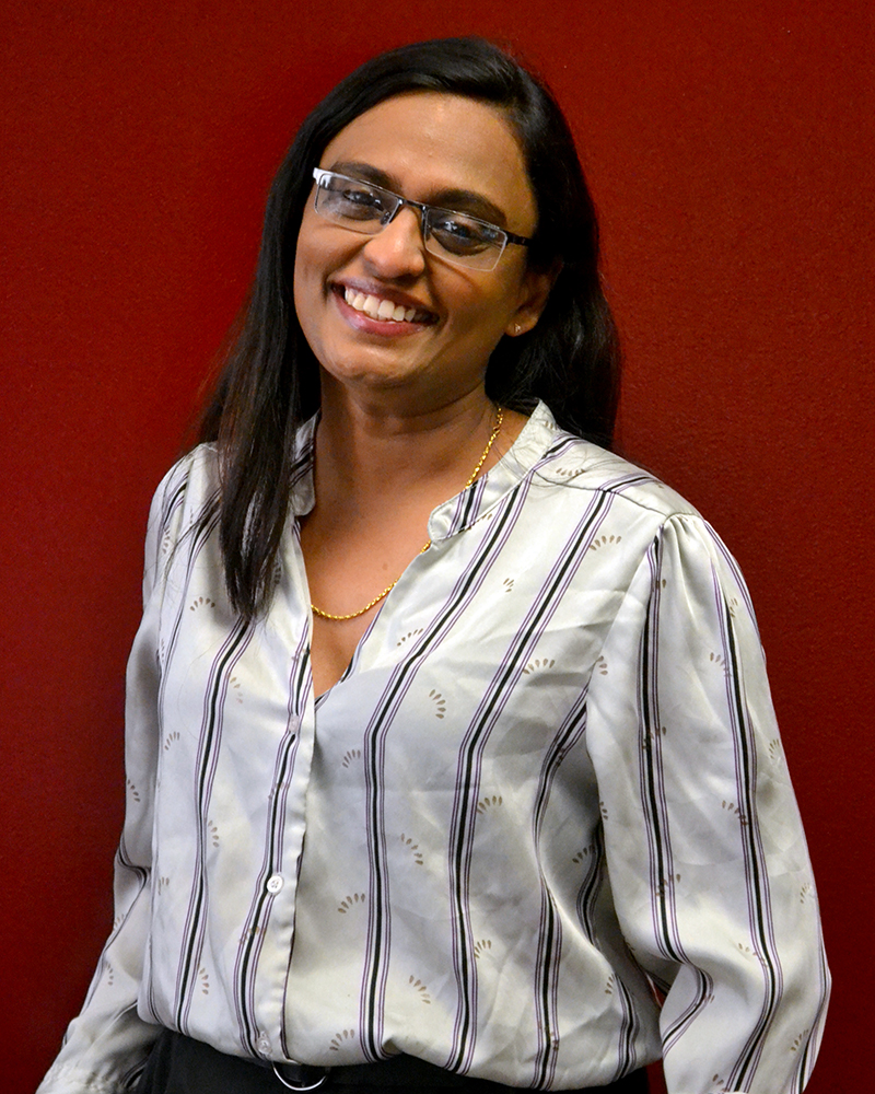 a portrait of a woman. she is dressed business casual.