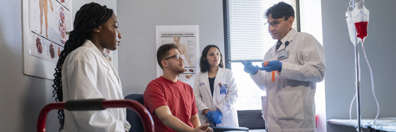 Nursing students practice drawing blood.