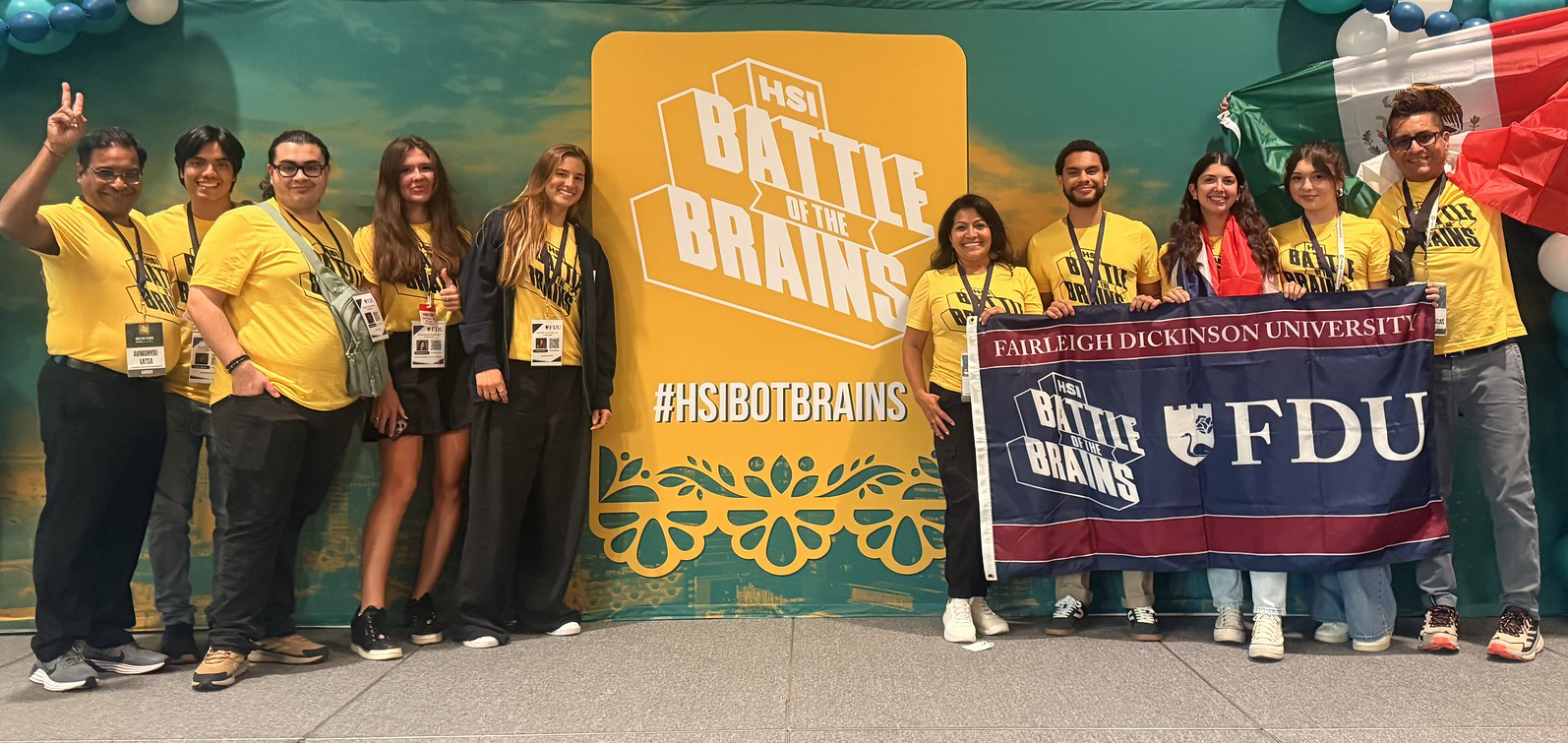 Group of faculty and students holding HSI Battle of the Brains banner