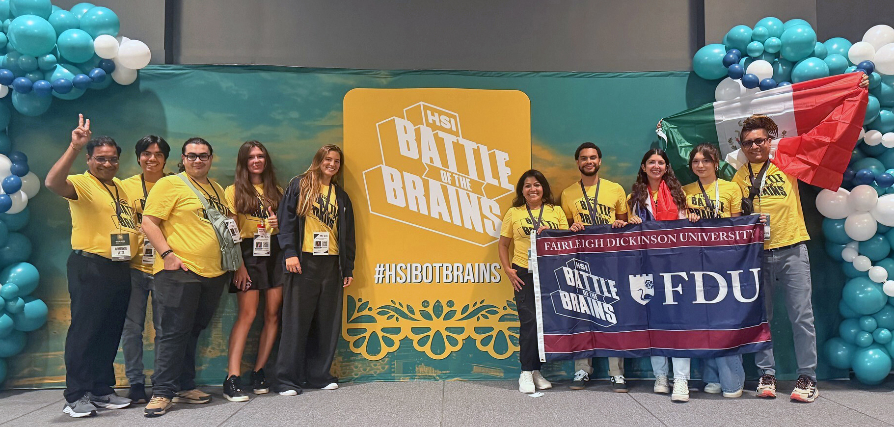 students and professors pose with an FDU flag and a HSI Battle of the Brains sign.