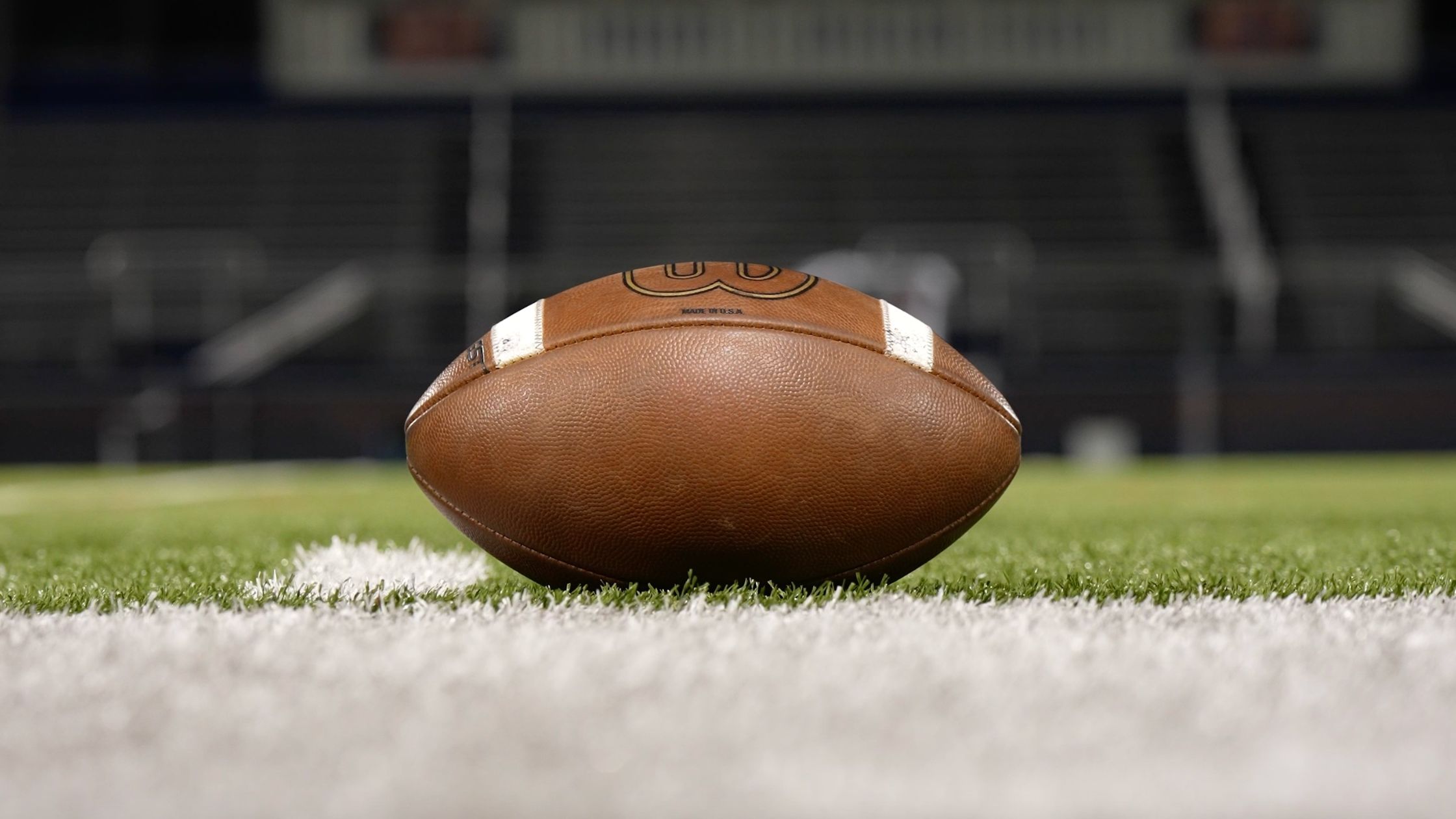 a football on the ground of a football field.