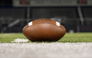 a football on the ground of a football field.