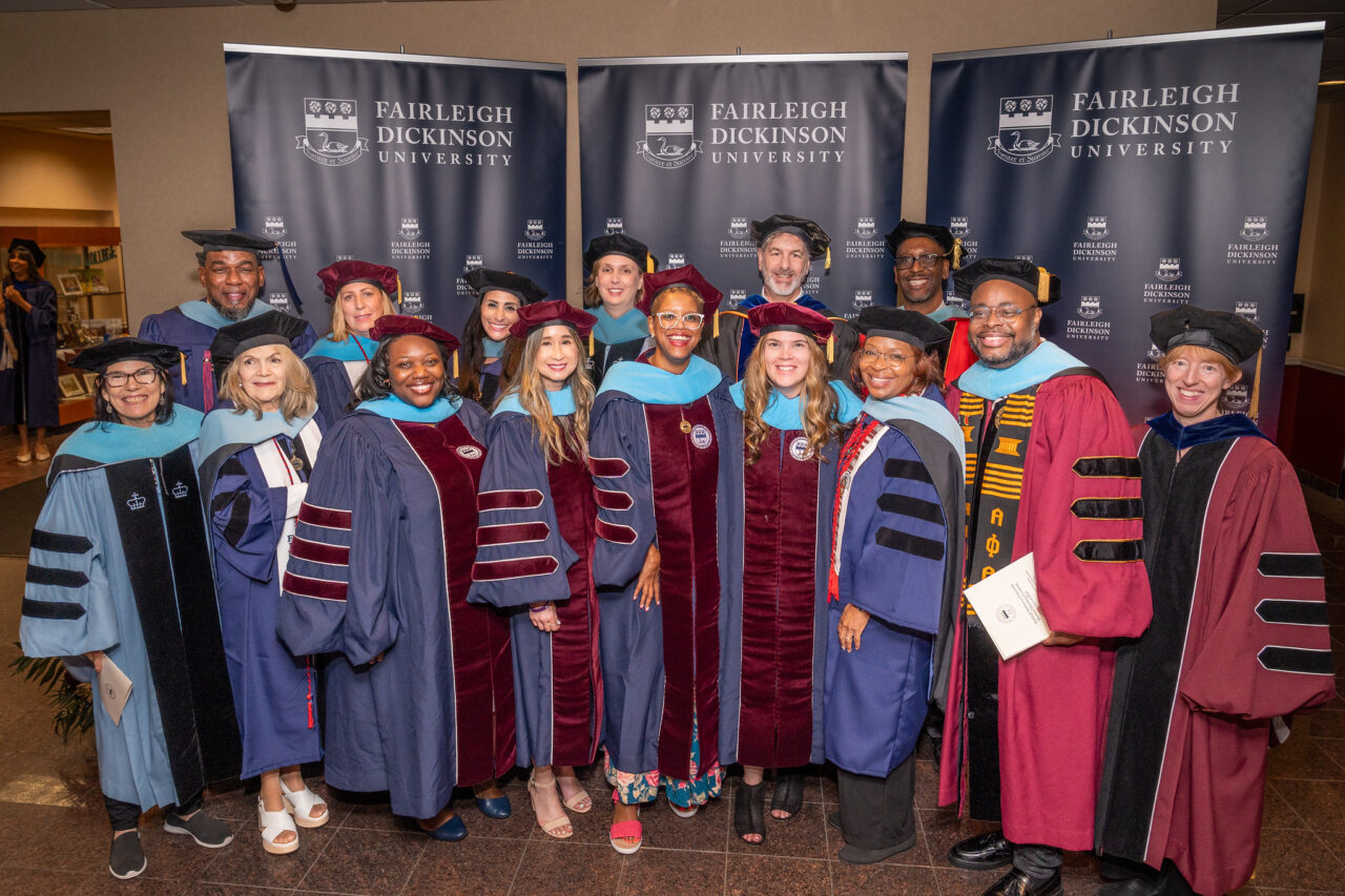 a group of doctorate students in regalia.