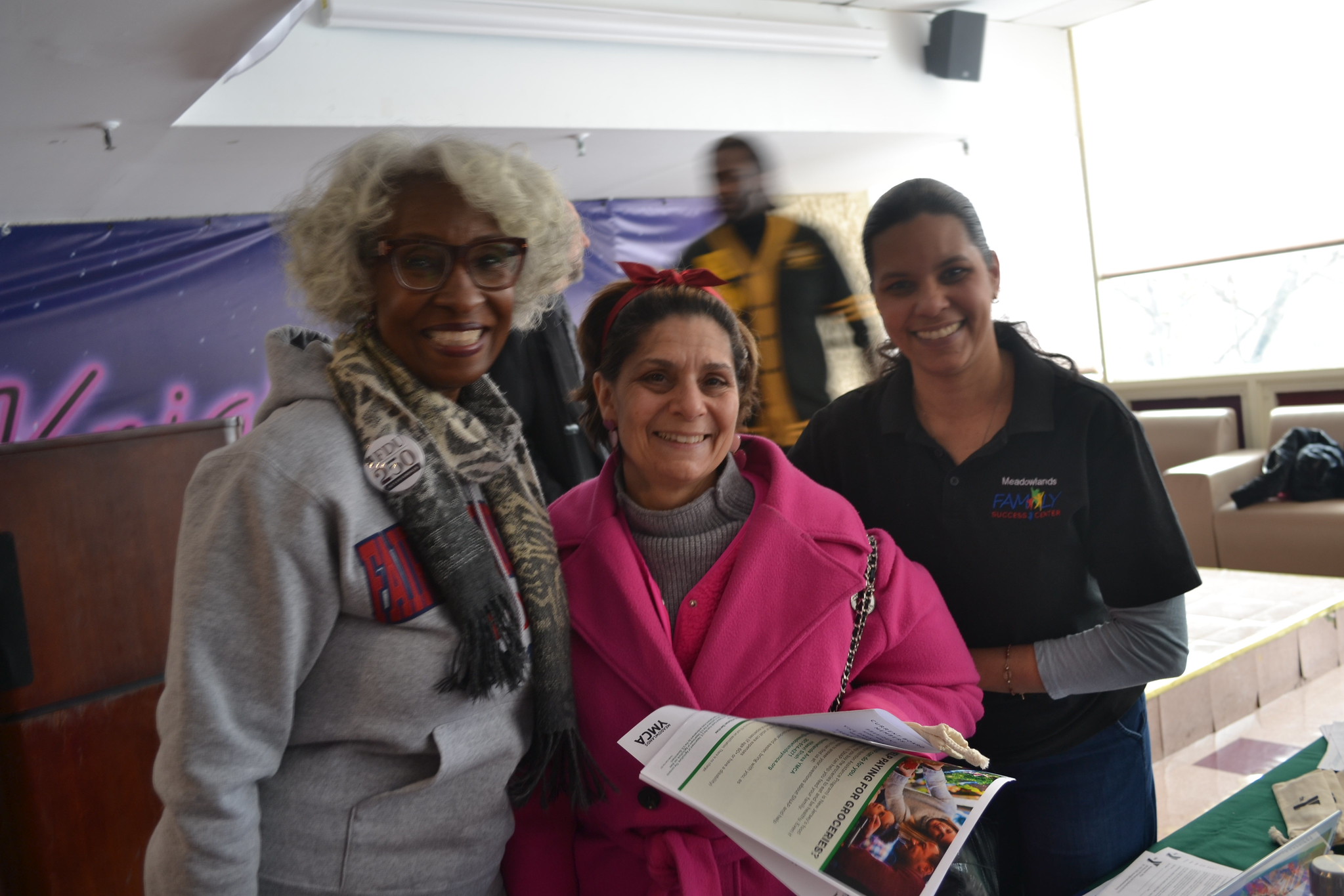 three women pose for a photo.