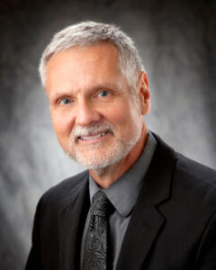 Closeup photo of a man with a suit and tie